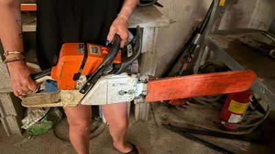 une femme qui tient une tronçonneuse à la main