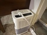 a small air conditioner sitting on the floor next to a door