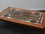 a wooden table with a mosaic on it
