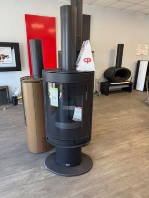 a black stove in the middle of a room