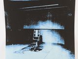 an image of a black and white photograph of a chair in a dark room