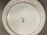 a white plate with a blue and white design on it