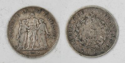 two silver coins, one of which is a woman and one of which is a man