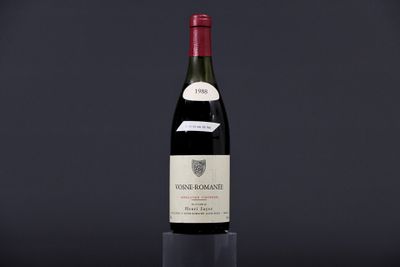 a bottle of wine sitting on top of a black table