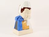 a figurine of a man with a hat on his head