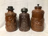 three brown vases sitting next to each other on a table