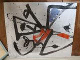 a picture of a painting on a shelf in a room