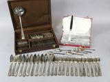 a lot of silverware in a case on the table