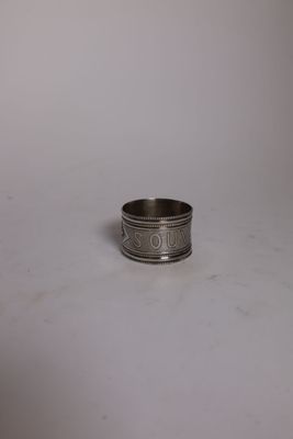 a close up of a silver ring on a white surface