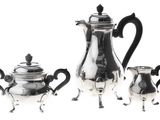 three pieces of silver tea and coffee set on a white background