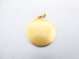 a gold plated pendant with a round design on a white background
