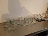 many glasses lined up on a table in a room