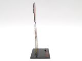 sculpture of a knife on a black base with a white background
