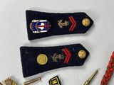 several military badges and pins are laid out on a white surface