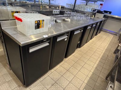 a large counter with a lot of bottles on top of it
