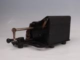 an old fashioned sewing machine on a white surface with a gray background