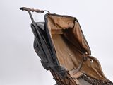 a baby carriage that is sitting on a white surface