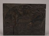 an old wooden box with a carved design on the front