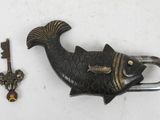 a fish shaped key and a key holder on a table