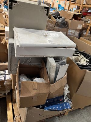 a pile of boxes and boxes of electronics on the floor
