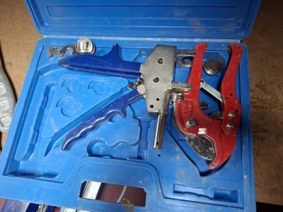 a blue tool box with tools in it on the floor