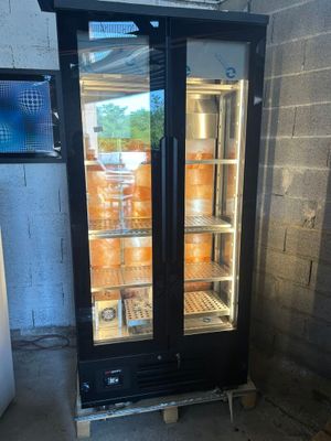 une photo d'un réfrigérateur à porte vitrée dans une pièce