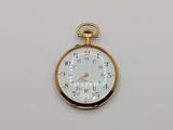 a gold pocket watch with a white face and numbers on it