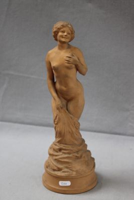 statue of a woman holding a flower in her right hand