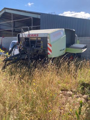 a tractor that is parked in the grass