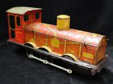 a toy train that is sitting on a black surface