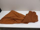 a brown blanket on a white table in a room