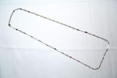 necklace with multi colored beads and silver chain on a white background