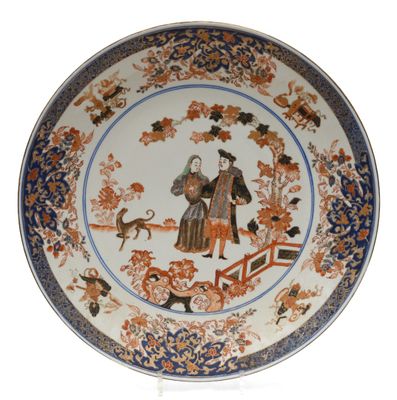 a plate with a picture of a man and a dog on it
