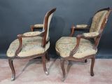 a pair of antique chairs with floral upholstered upholstered seats