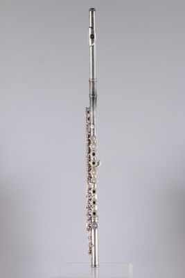 the flute is in a clear glass holder on the table