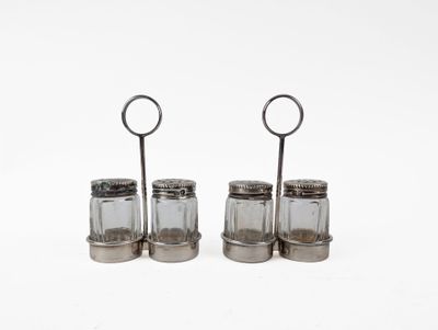 three glass salt and pepper shakers on a white surface