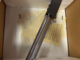 a knife in a box with a piece of paper in it