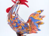 a colorful rooster figurine on a white background