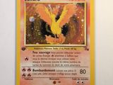 the pokemon card has a picture of a yellow bird on it ' s back