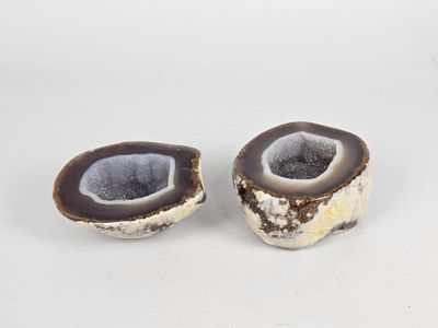 two pieces of agite on a white surface with a white background
