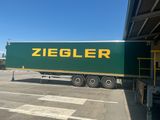 a large green truck that is parked in a parking lot