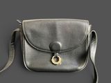 leather cross body bag with a metal buckle