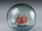 a glass ball with a boat inside of it