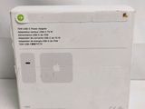 an apple power adapter box sitting on top of a white table