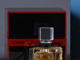 a bottle of perfume next to a box on a table