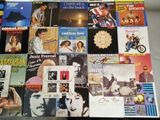 a lot of different album covers that are on a table