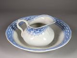 a small blue and white bowl and saucer on a saucer