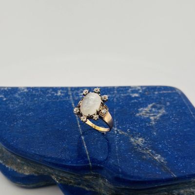 a close up of a ring on top of a blue stone