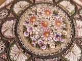 a close up of a plate with flowers and butterflies on it