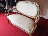 a white couch sitting on a red carpet in a room